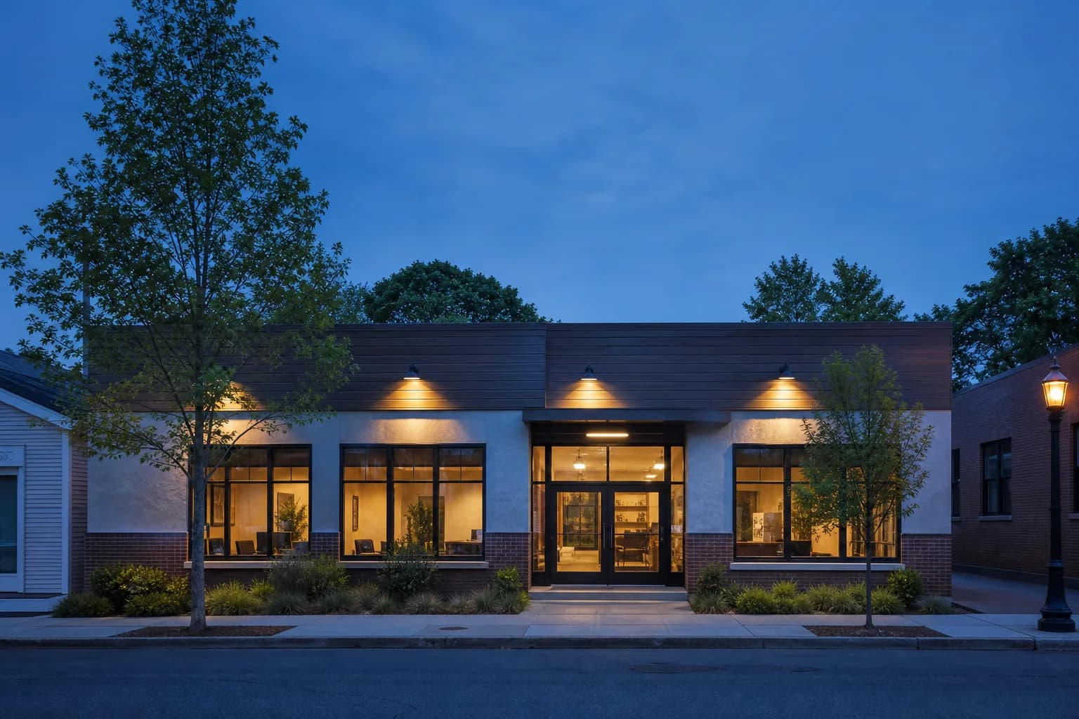 Local commercial building with warm exterior lights at dusk