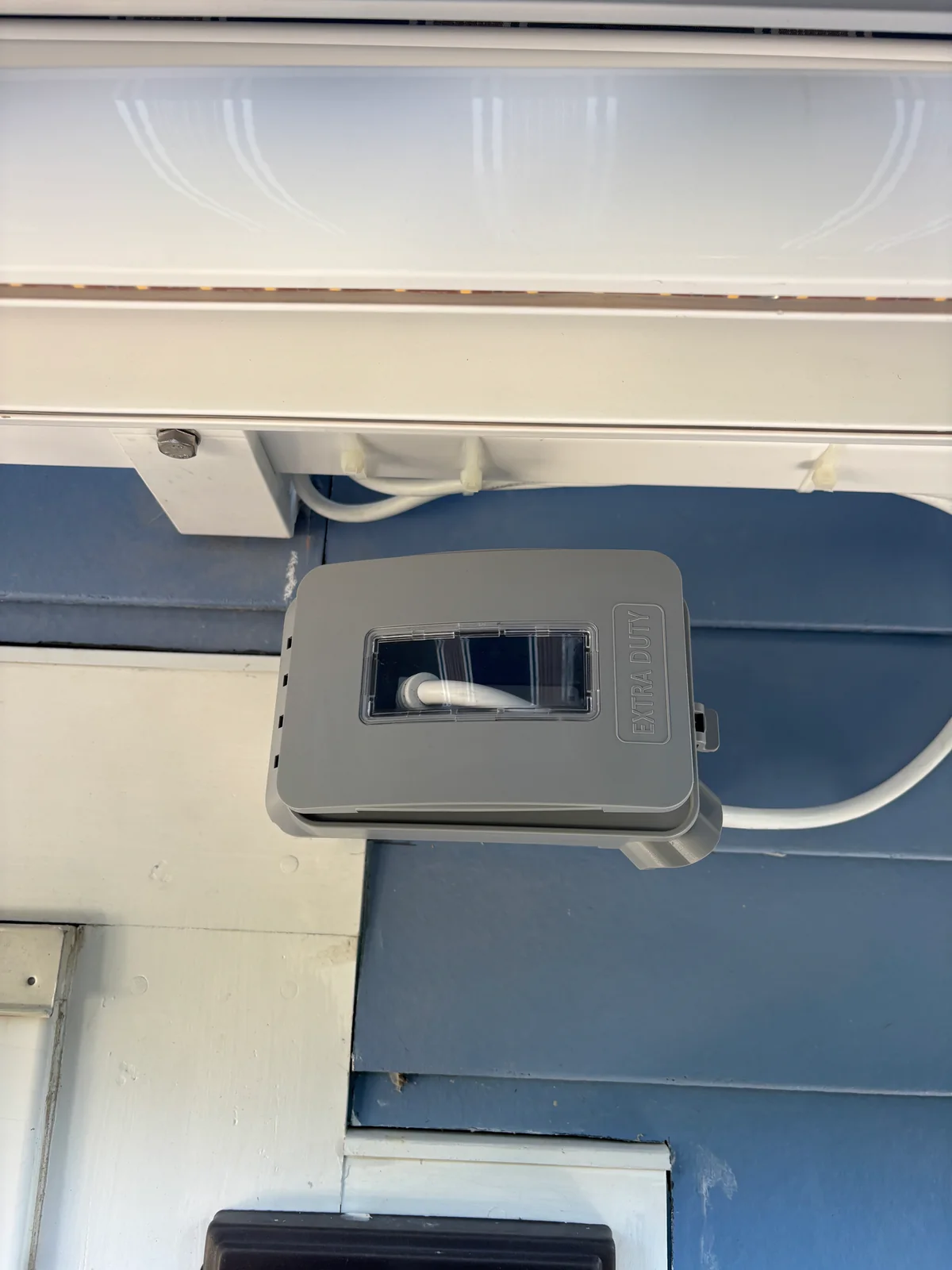Exterior disconnect and conduit installed beside a building entrance