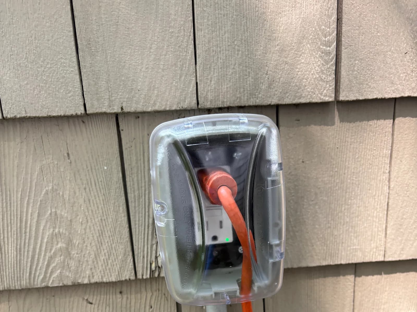 Heavy-duty outdoor power connection protected by a weather-resistant cover