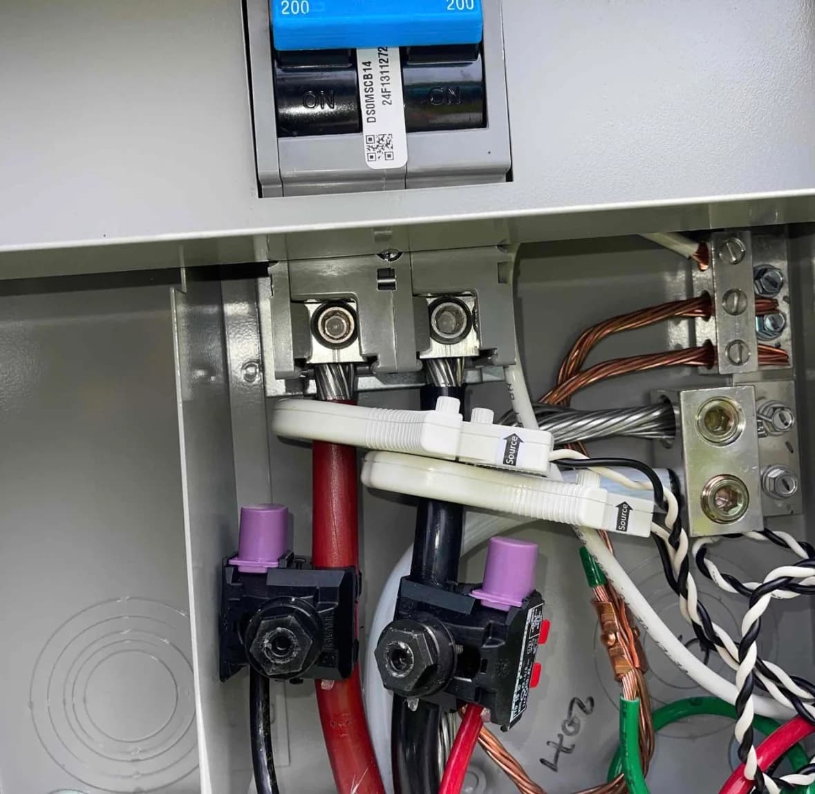 Open solar control panel showing organized conductors and protective components